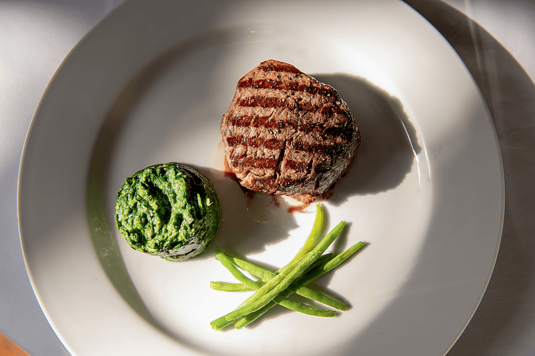 Elbert’s Steak Room USDA Double Gold Filet Mignon, with a side of creamed spinach