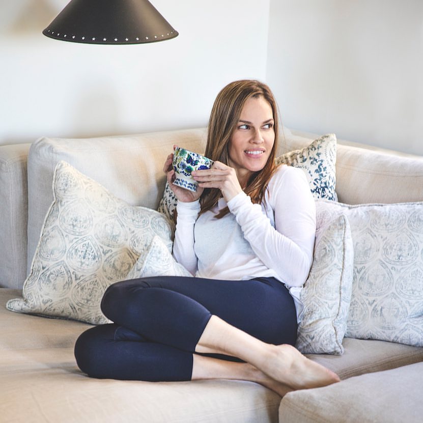 Hilary Swank lounging in her home