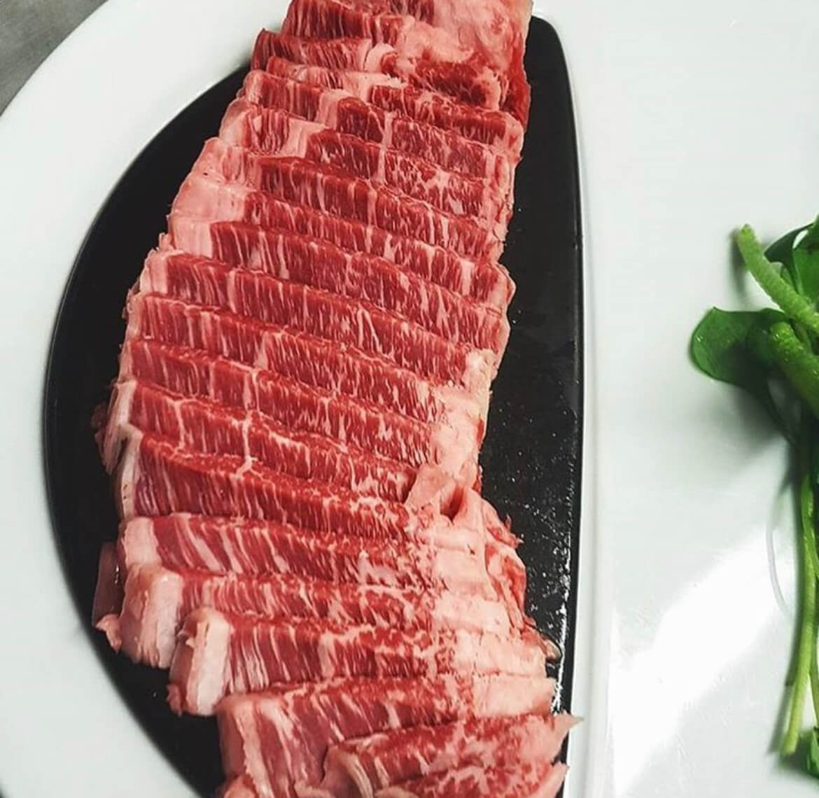 Raw Kobe Beef with luscious white fat streaks weaving through it