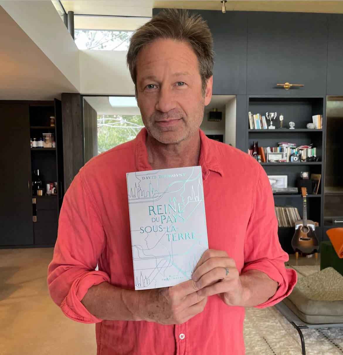 Duchovny holding a book