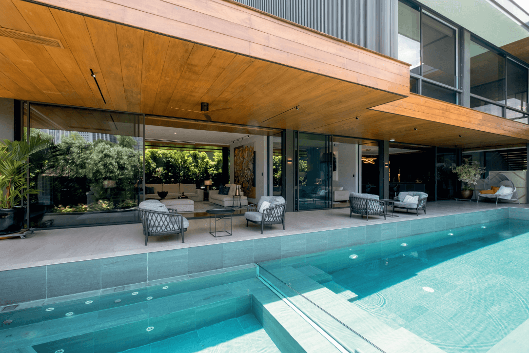 On the deck by the pool, Patricia Urquiola's Fat-fat small table is sandwiched between Antonio Citterio's Erica outdoor chairs.