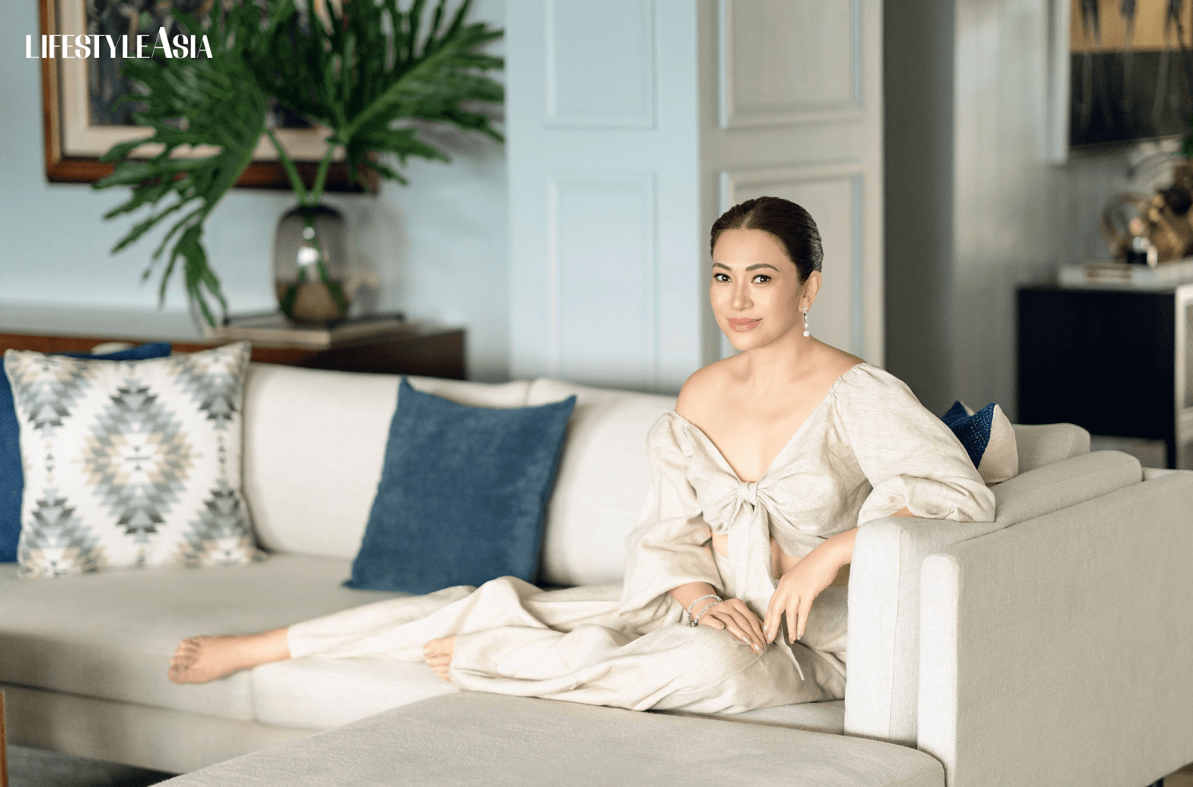 Oatmeal linen off shoulder tie front top and matching pants, TRUDE LIZARES; Asymmetric diamond dangling earrings, JMA JEWELRY.