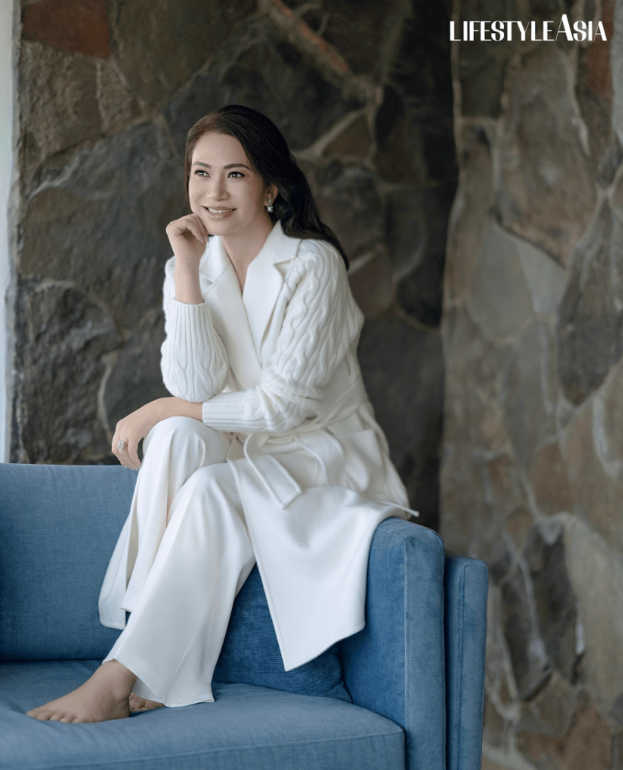 Ivory cashmere cable knit trench coat and trousers, MAX MARA; Asymmetric diamond dangling earrings and ring, JMA JEWELRY.