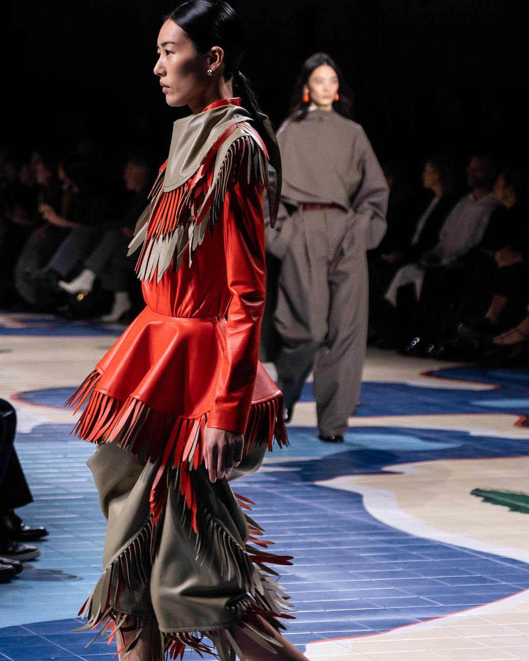 Close up on a model with a fringe-like styled ensemble