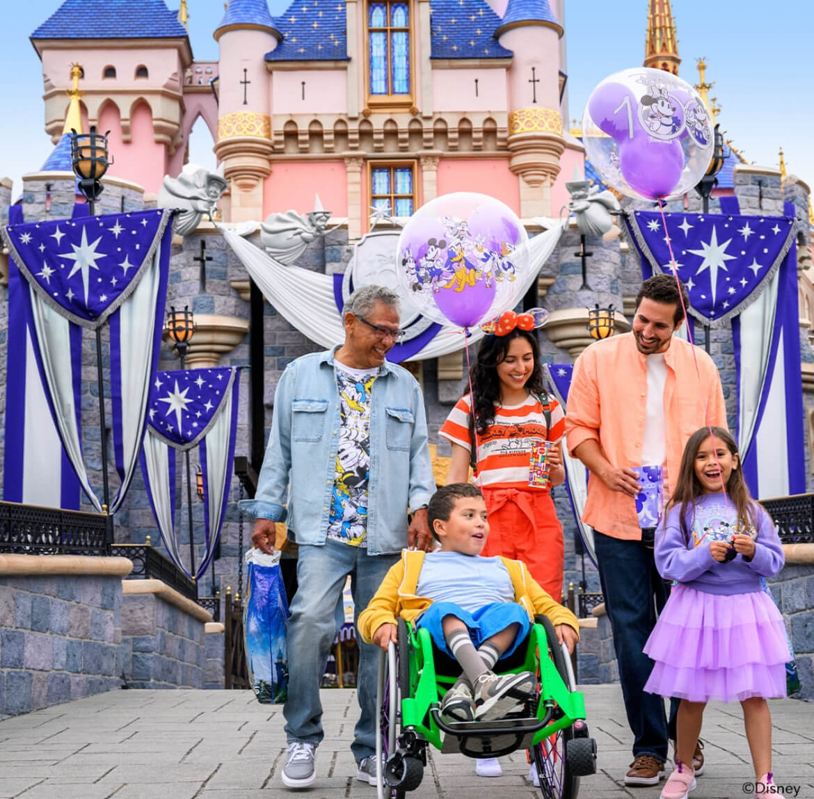 A family walking in front of the Disney castle. 