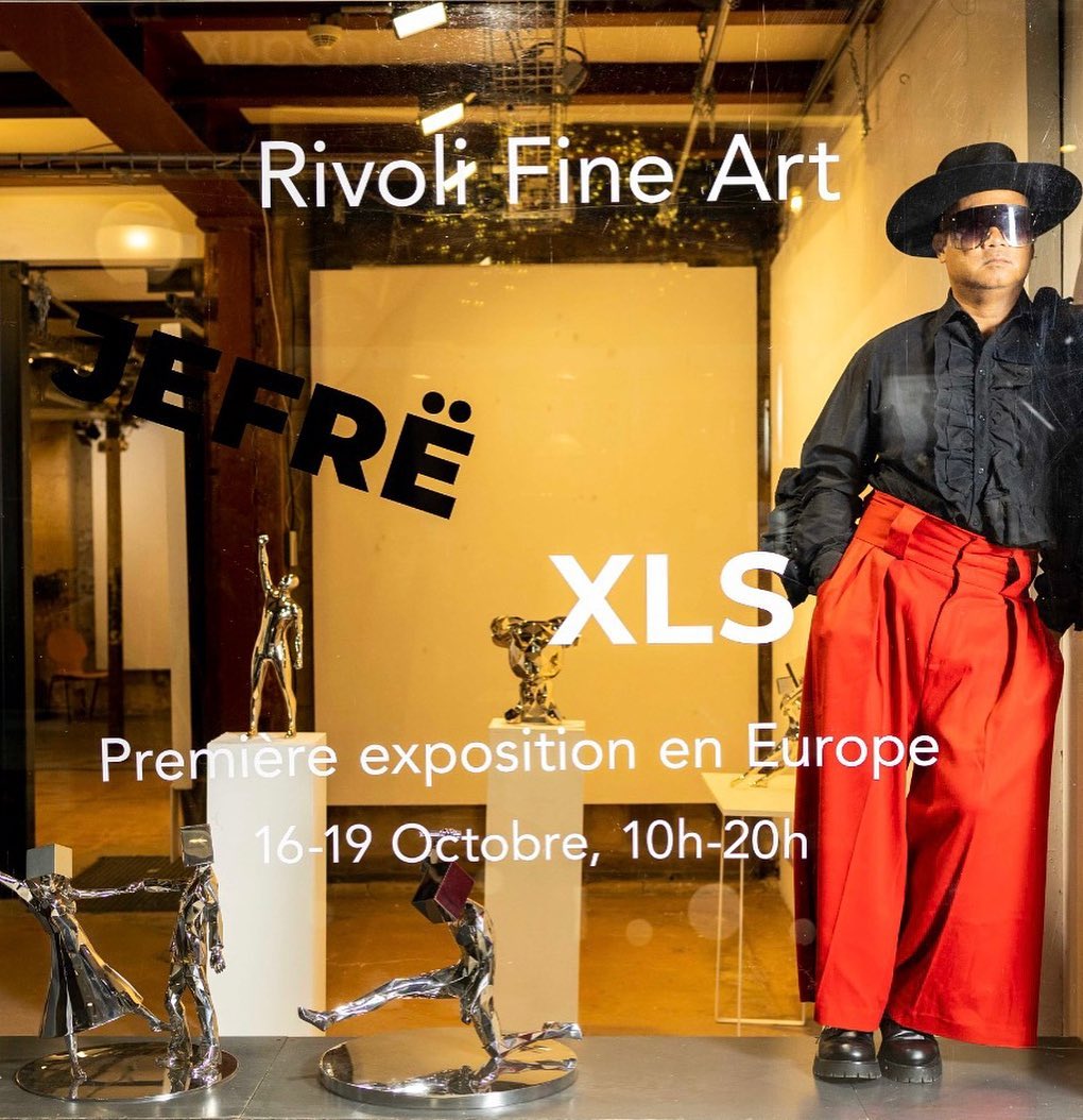 JEFRË beside his sculptural pieces from the XLS exhibition