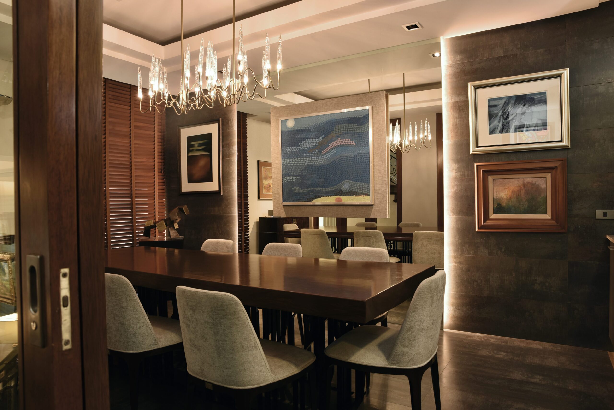 Artworks from the 1970s to the 1980s are gathered in the dining room. The table is made from a solid slab of narra on a metal base by Steven Sy of Comanche Steel.