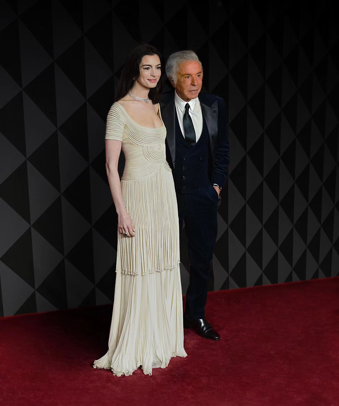 Anne Hathaway poses with Valentino’s co-founder, Giancarlo Giammetti