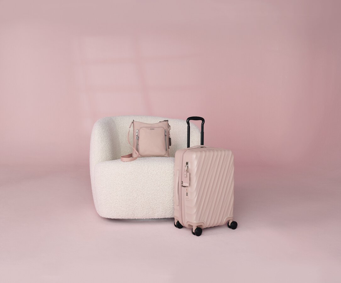 Voyageur Tyler Crossbody in Light Mauve; 19 Degree International 4-Wheeled Expandable Carry-On in Mauve Texture