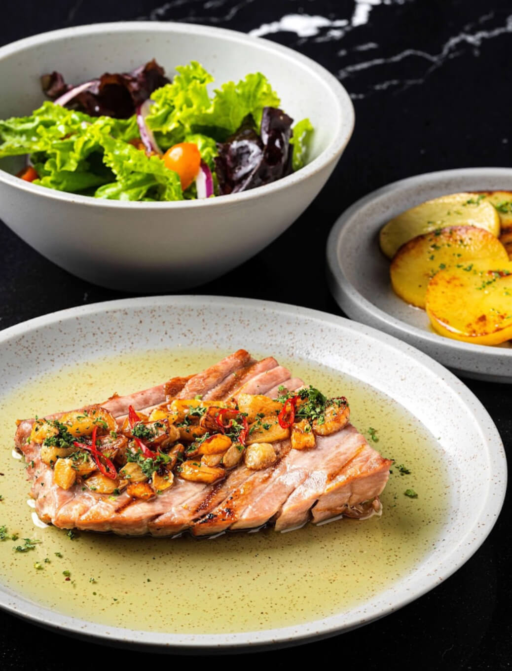 Ventresca de Atun (Grilled tuna belly with confit potato, fried garlic and chili oil)