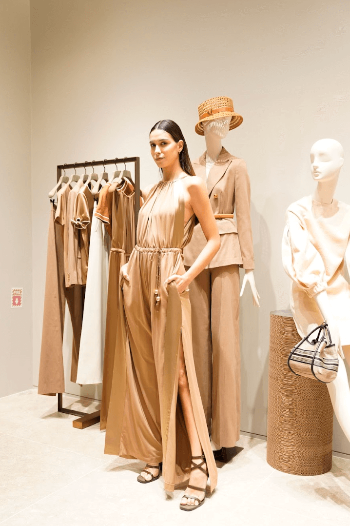 Backless sundresses inspired by gardeners' aprons and triple-layered chiffon gowns with gaberdine straps transition the tough chic aesthetic from day to evening wear.