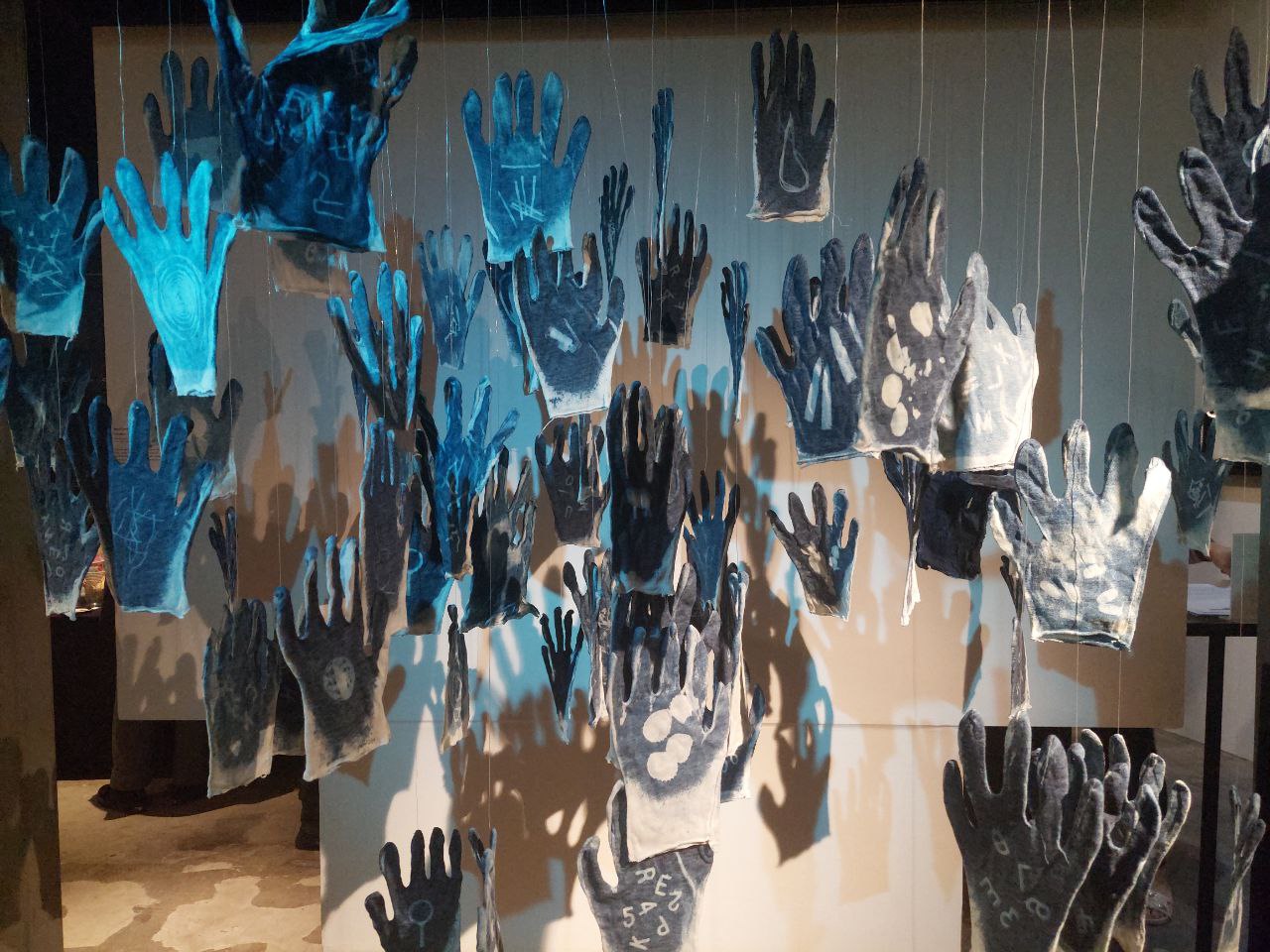 Untitled installation of cotton gloves and “Hands” (1990s-2022); both by Neal Oshima