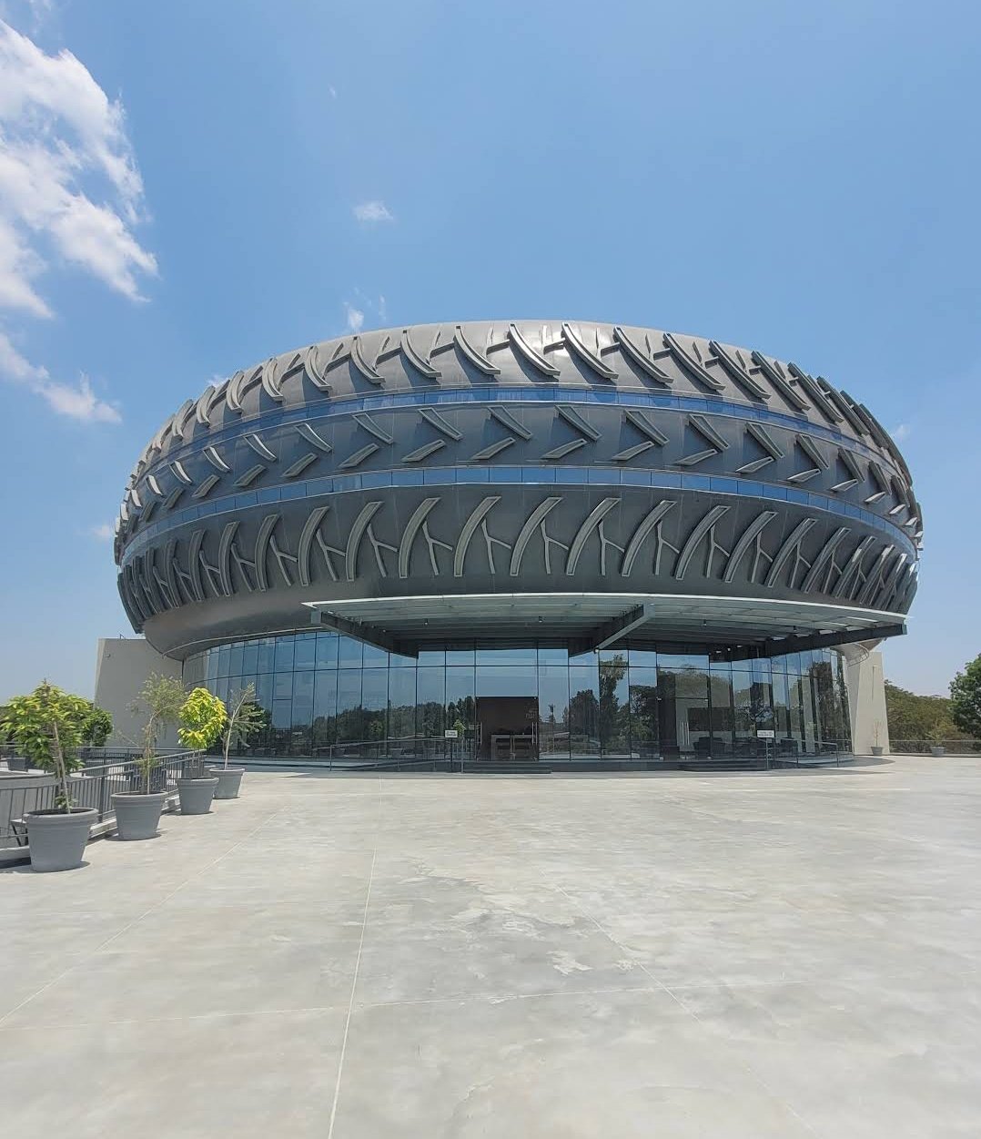 The exterior of the Payana Museum in India has a roof that resembles a huge tire