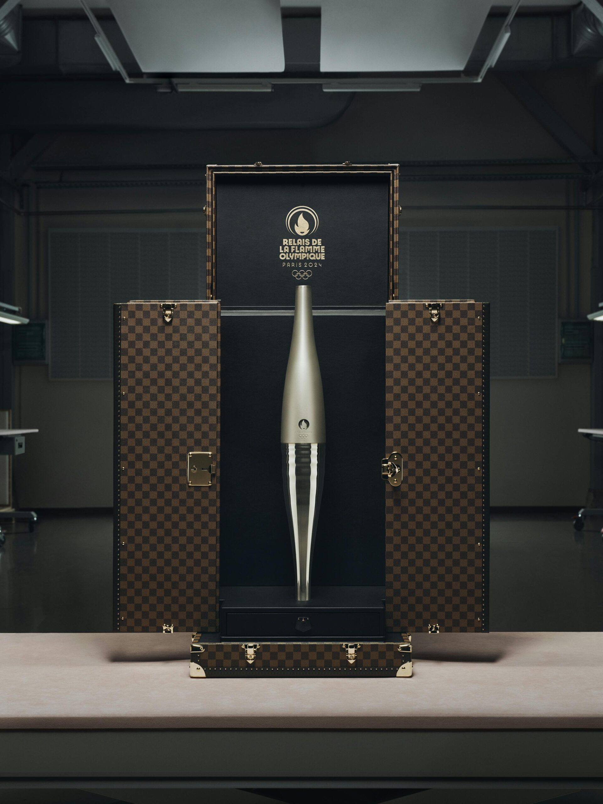 LEFT: Louis Vuitton's Medal Trunk. RIGHT: Louis Vuitton's Torch Trunk.