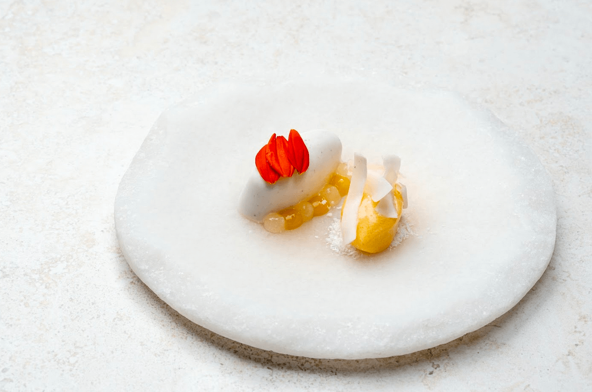 LEFT: Coconut panna cotta, mango gel, citrus sorbet. RIGHT: Lamb korma, basmati pulao with mushrooms, compressed naan.