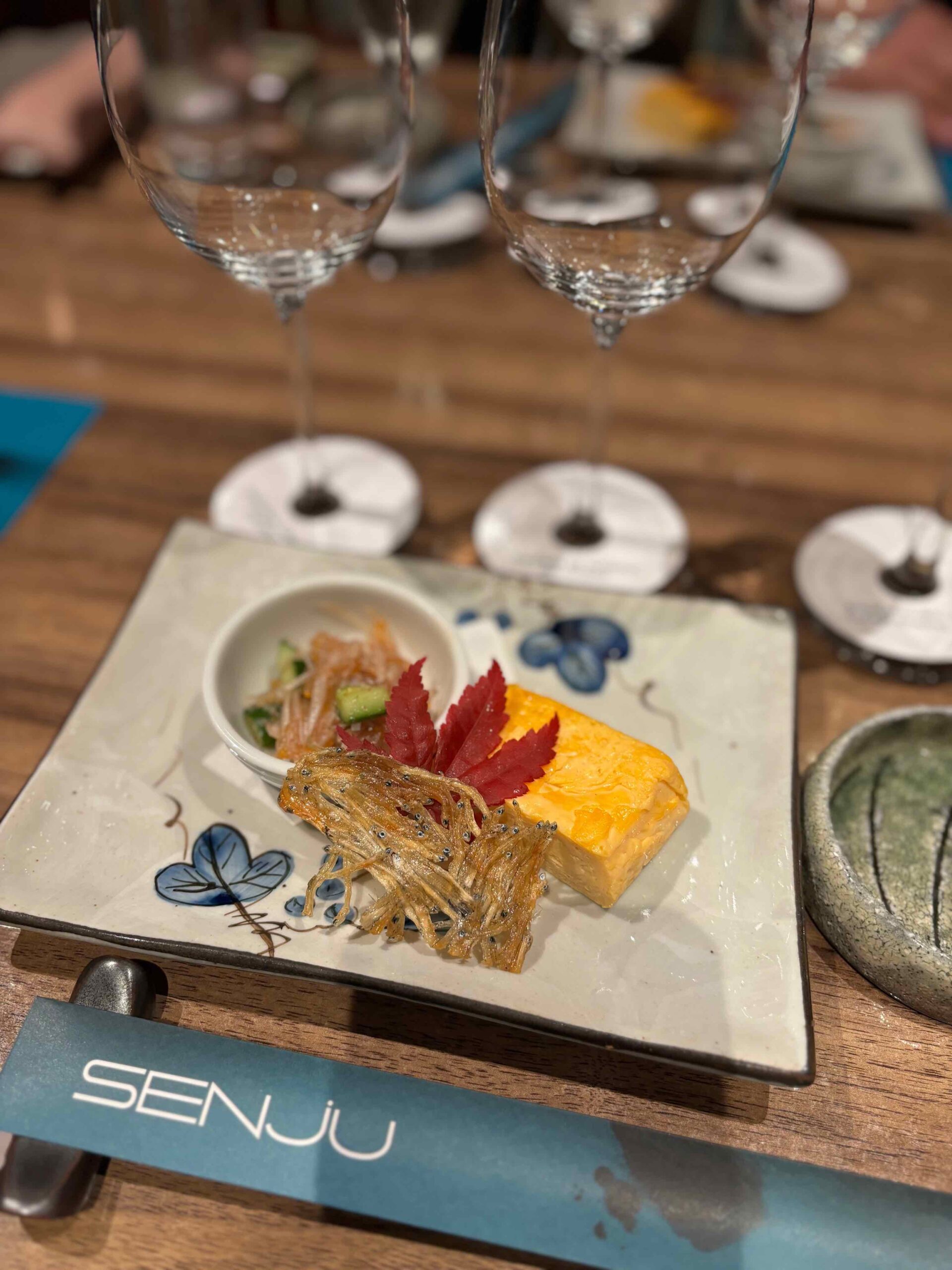 Sakizuke featuring Tatami Iwashi, dried baby sardines sheet; Umesuisho, shark cartilage with plum sauce; and Dashi Maki Tamago, dashi rolled omelette