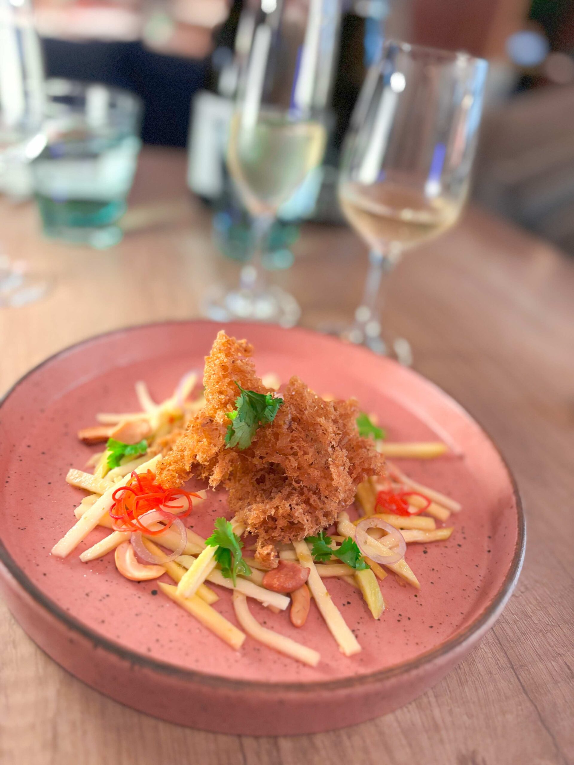 Yam Pla Krob, a crispy fish salad with green mango, cilantro, shallot, and chili dressing