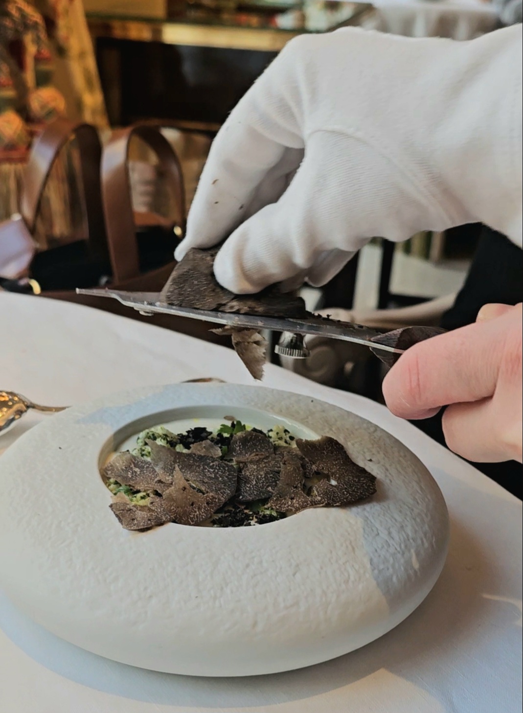 Melanosporum truffles (black Périgord truffle) freshly shaved on "Monarch" celery risotto and lovage with "Carnaroli" rice infusion/Photo by Pepper Teehankee