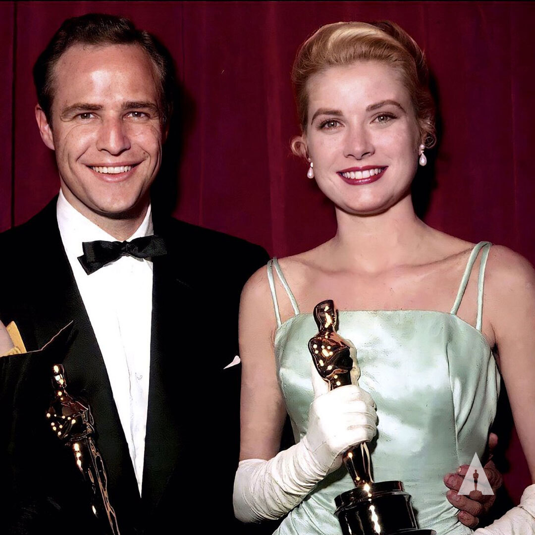 Grace Kelly in Edith Head, with William Holden and Marlon Brando at the Oscars