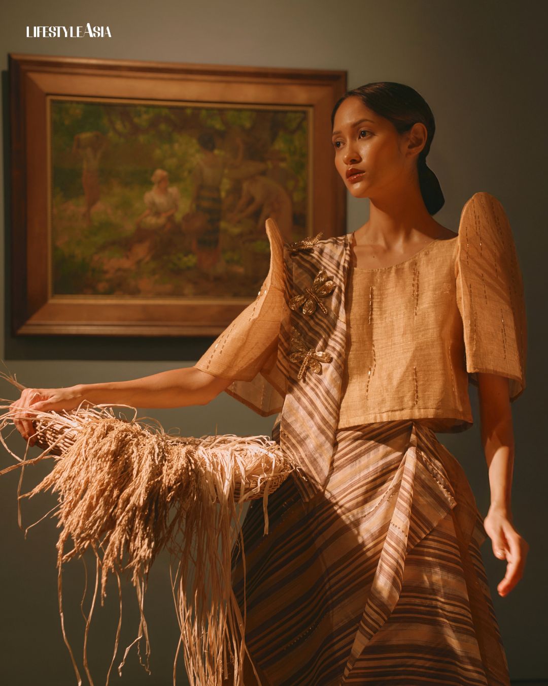 “Under the Mango Tree” (1935) by Fernando Amorsolo, from the collection of the Government Service Insurance System; Terno by Ram Silva, Ramon Valera (Bronze) awardee of TernoCon 2025, inspired by the countryside splendor of Amorsolo, incorporating handwoven fabrics and natural fibers artists 