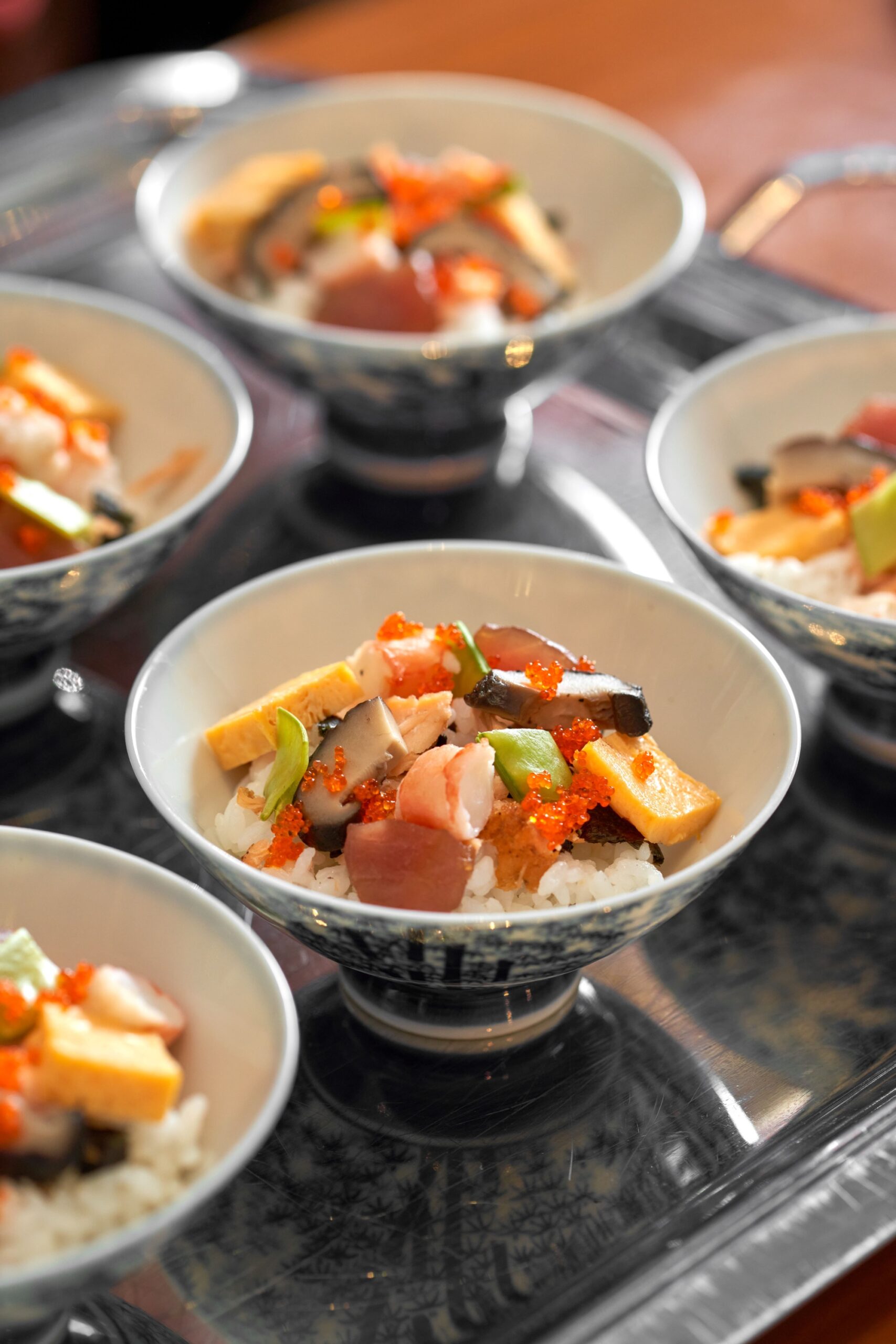 Chirashi Sushi with tuna, shrimp, tamago, shiitake, cucumber, and sesame