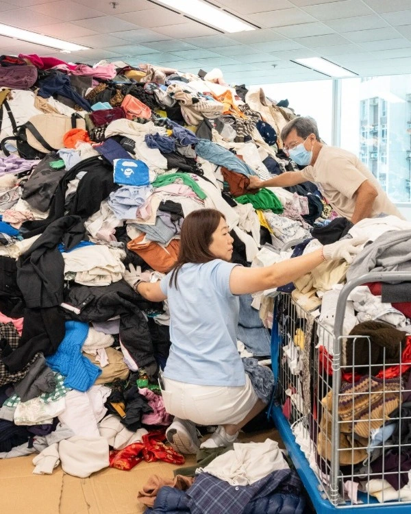 Plastic in Fashion: Redress volunteers sorting through a pile of Clothes