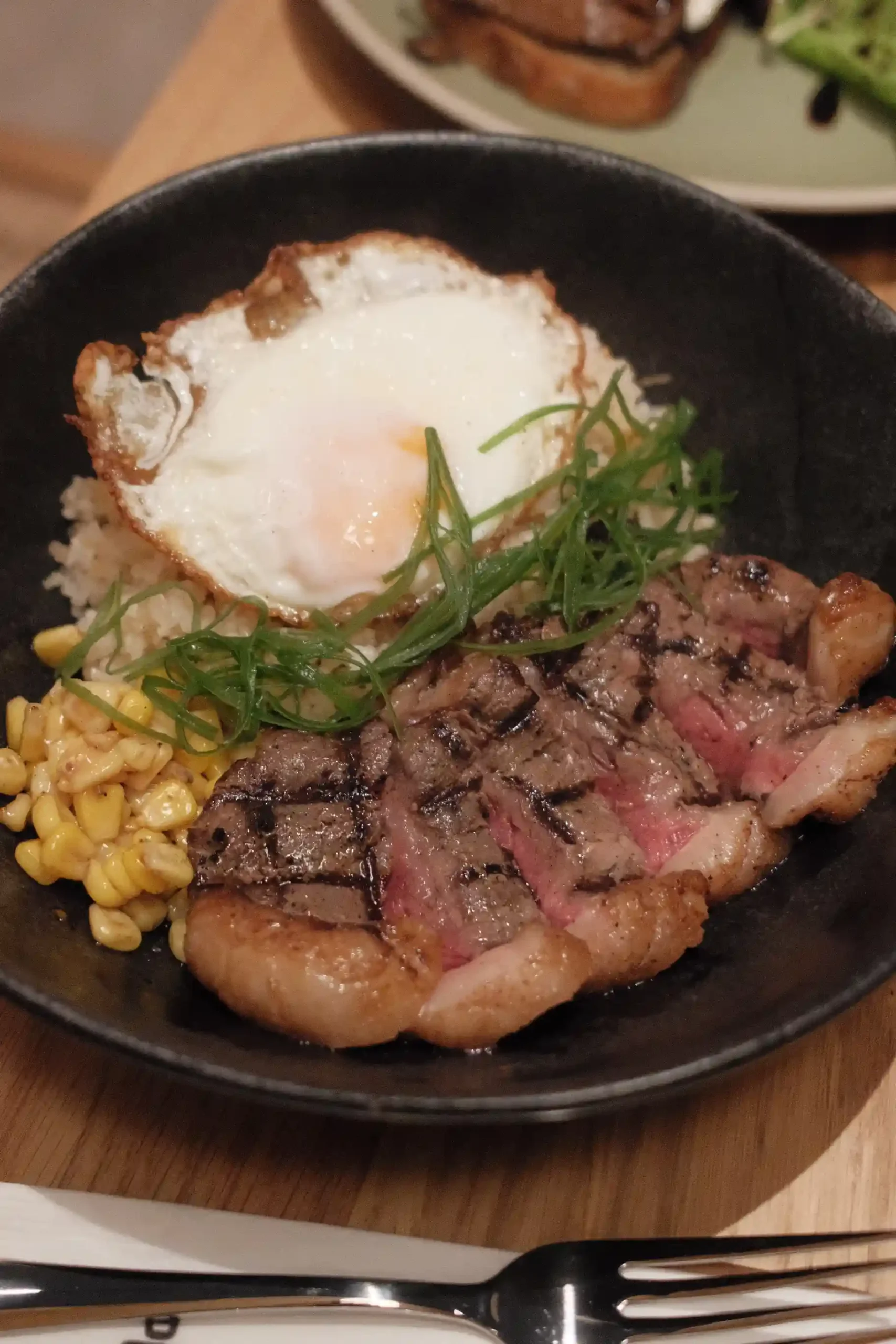 Dishes at the Spotted Pig's Proscenium Rockwell branch: Steak Rice; Avocado Toast
