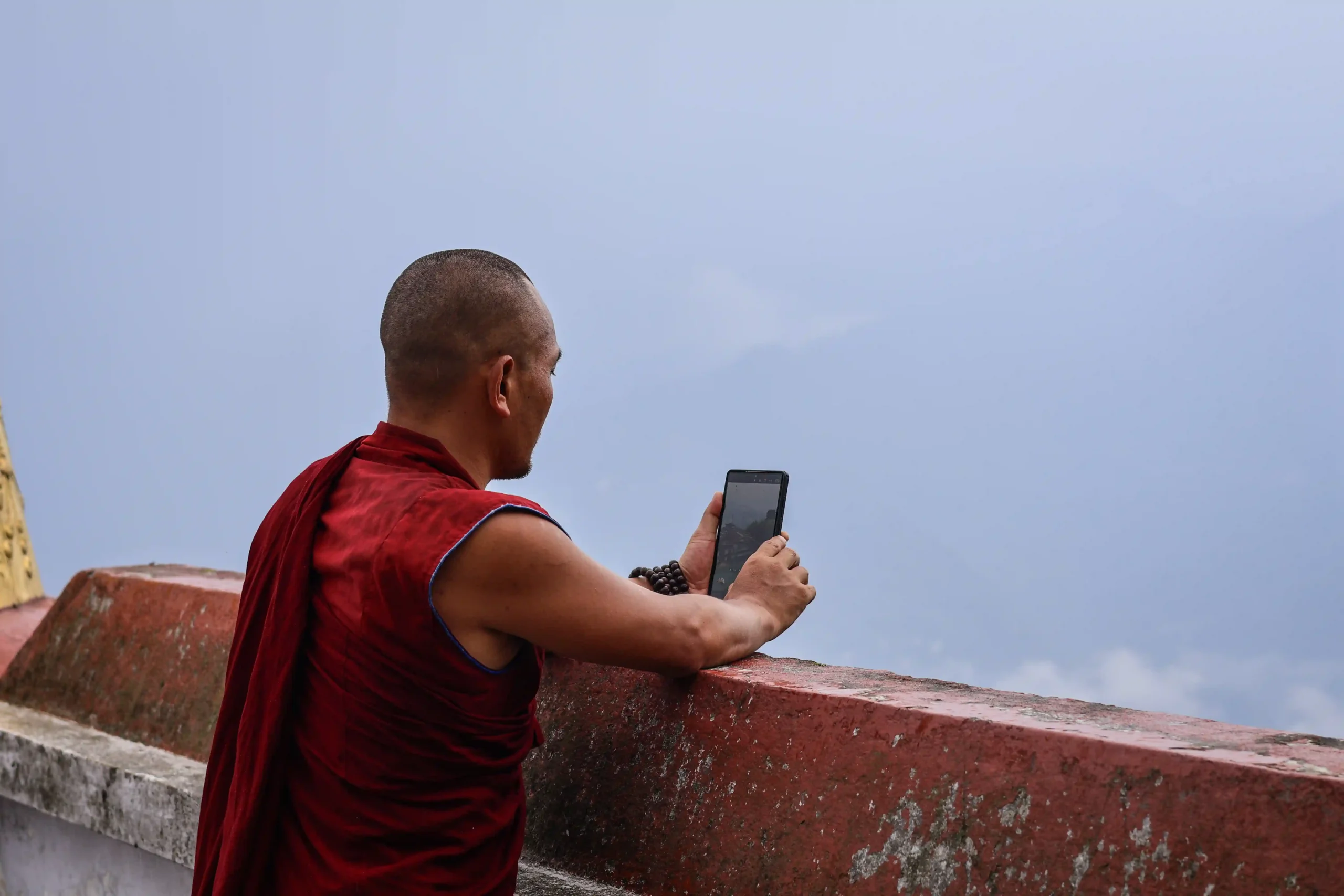 A monk using a cellphone in Rumtek, India