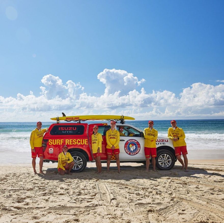 Surf lifesavers with an Isuzu patrol vehicle at the beach