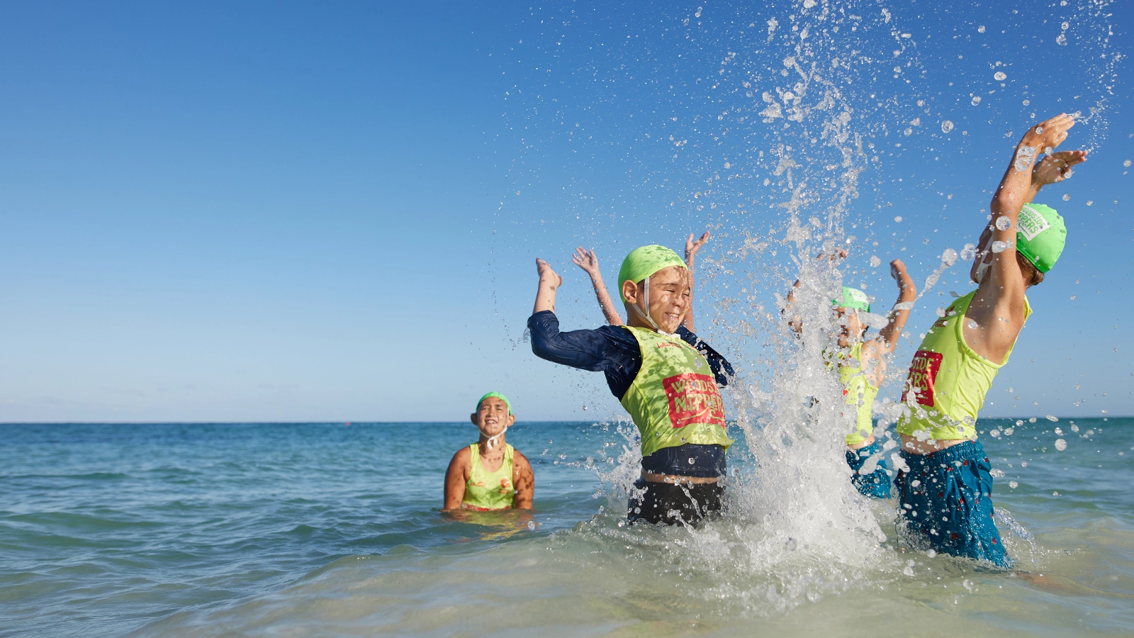 Woodside Nippers running into the shallows at the beach