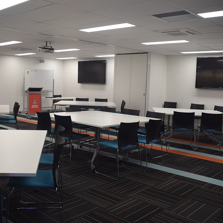 A training and conference room set up with tables and chairs
