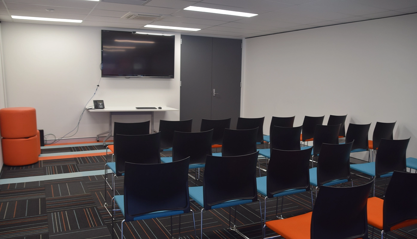 A training room with a presentation screen