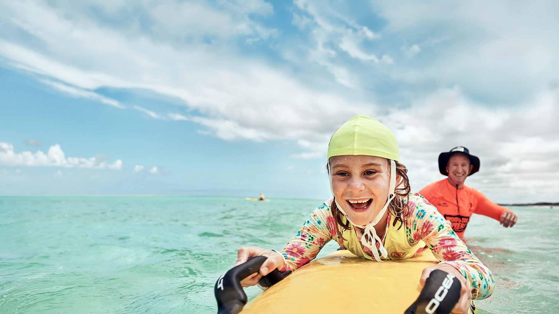 A young nipper paddling a board during a water safety session