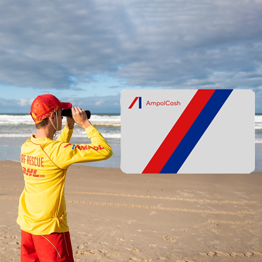A surf lifesaver on the beach beside an Ampol card graphic