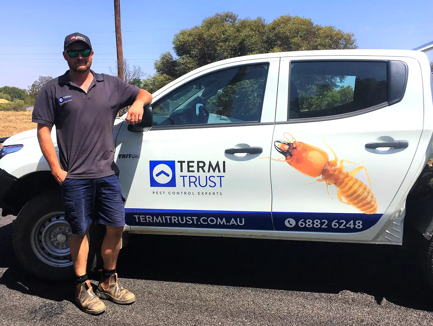 James Sutton, franchisee located in Dubbo, NSW, standing next to a Termitrust Pest Control branded ute