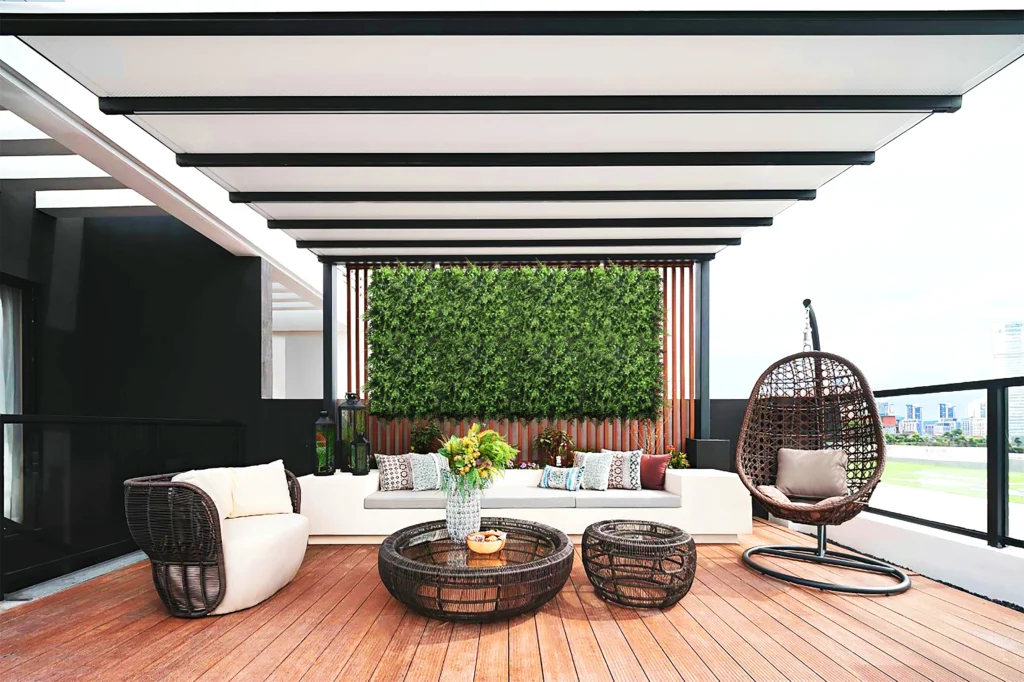 Multiple artificial green wall panels attached to a distant wall under a patio