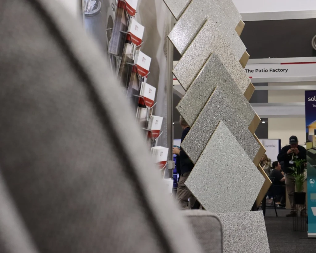 Sample boards of different epoxy flooring colours on a display stand at Home Show Perth