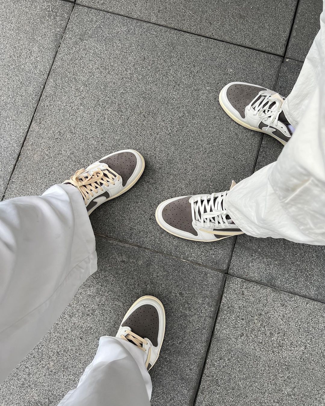 Kim Kianna Dy and Dwight Ramos wearing Air Jordan 1 Low x Travis Scott in 'Reverse Mocha'