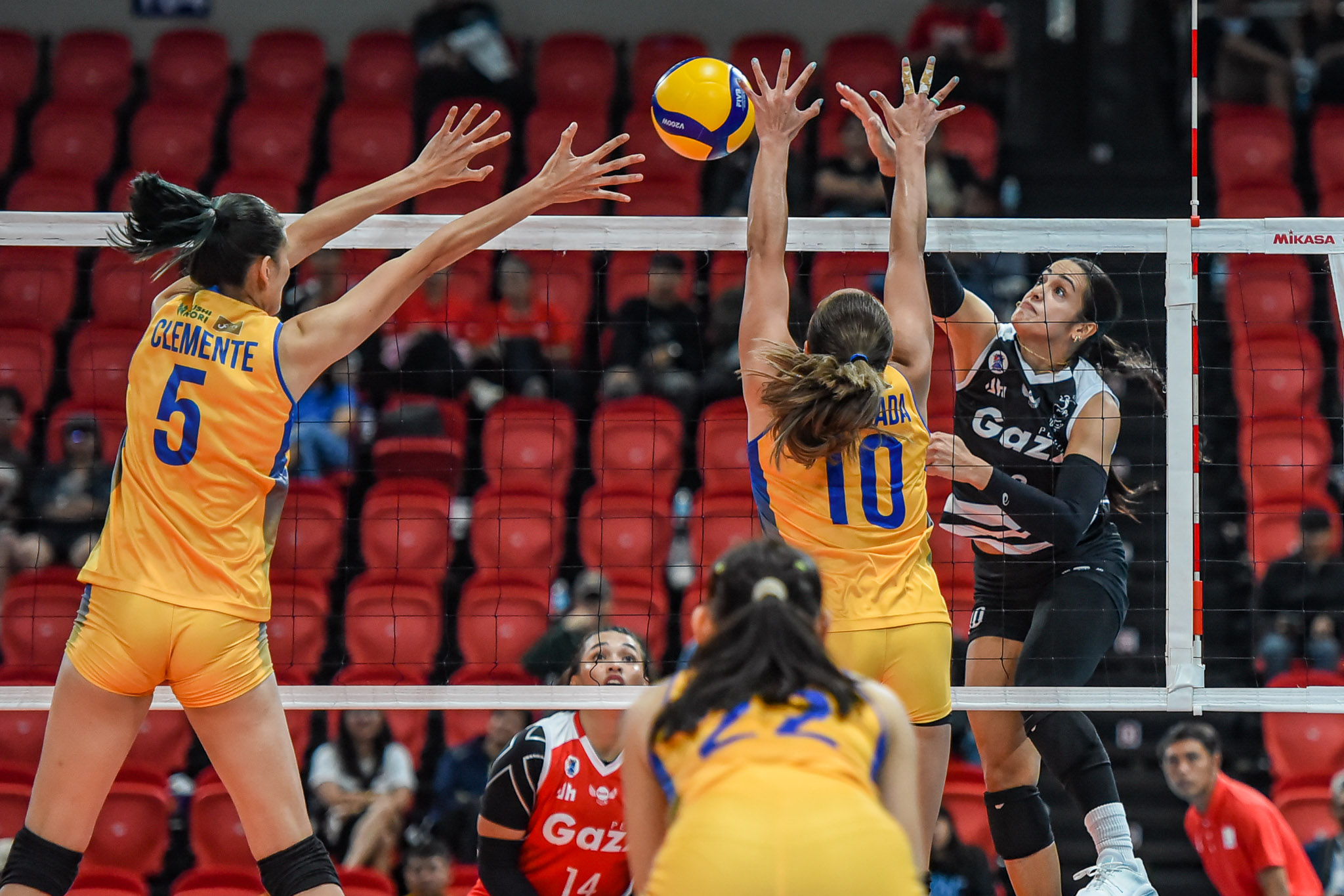 Capital1's Iris Tonelada and Des Clemente against Petro Gazz's Brooke Van Sickle