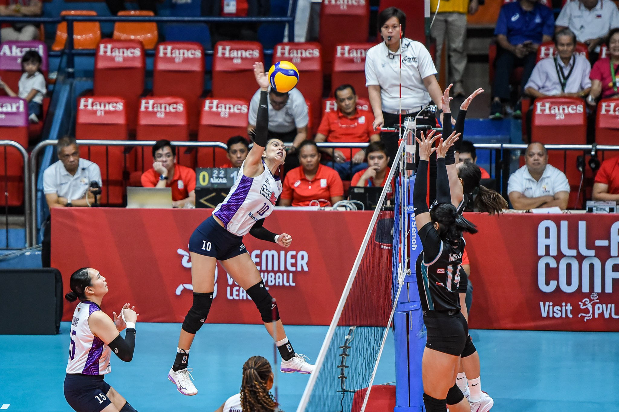 Kat Tolentino against a double block by the Highrisers.
