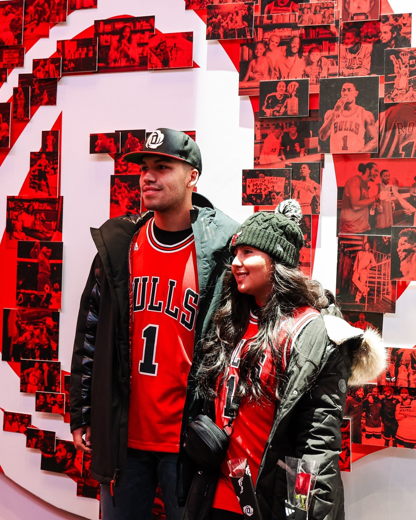 Bulls fans pose in a separate section of the Derrick Rose experience, which features his iconic logo recreated with action shots.