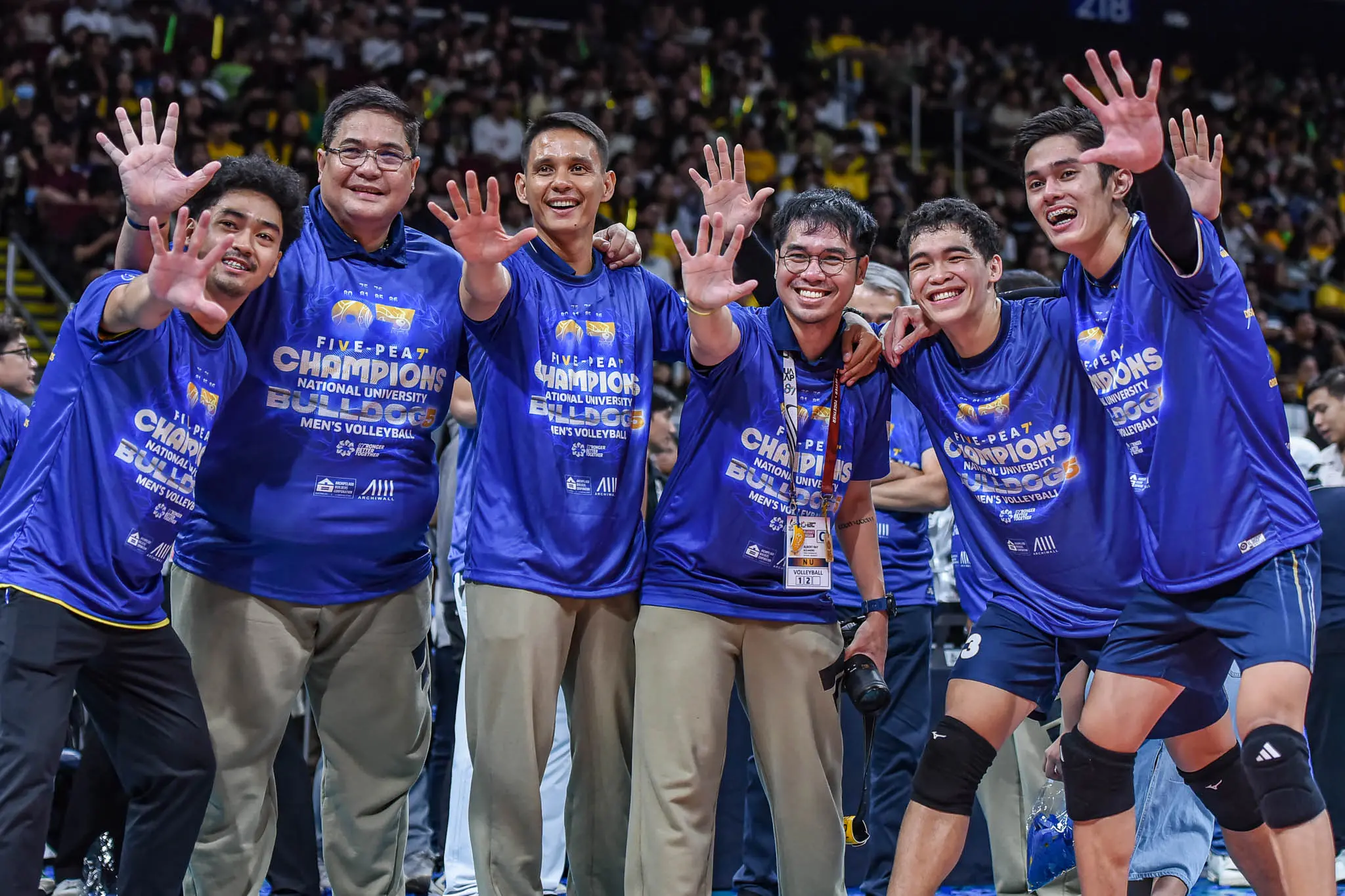 A shot of NU assistants Dong Dela Cruz, Jessie Lopez, and setters Jeffe Gallego and Greg Ancheta
