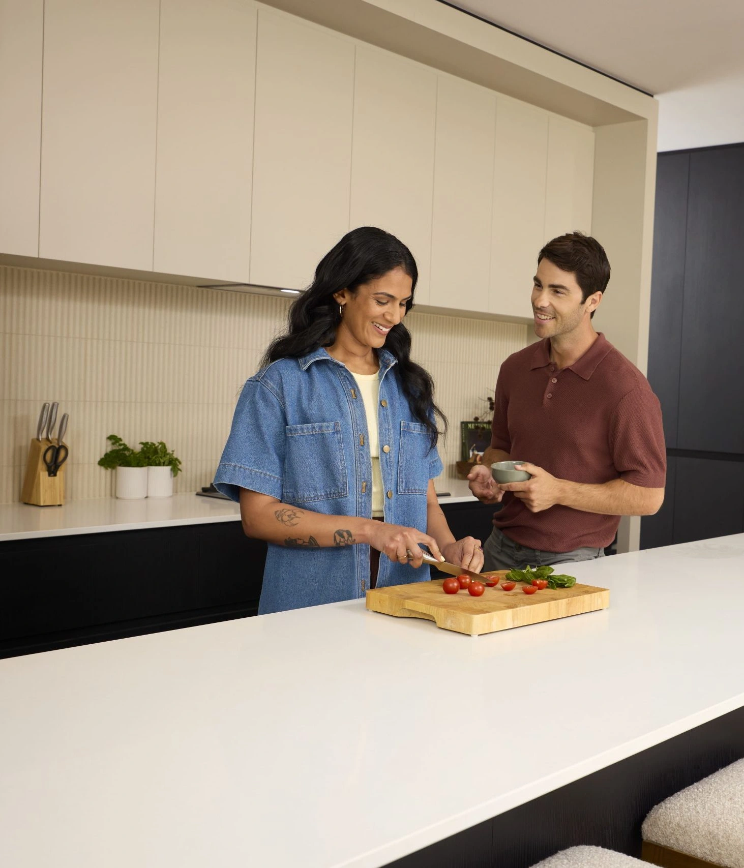 Smiling couple preparing vegetables together