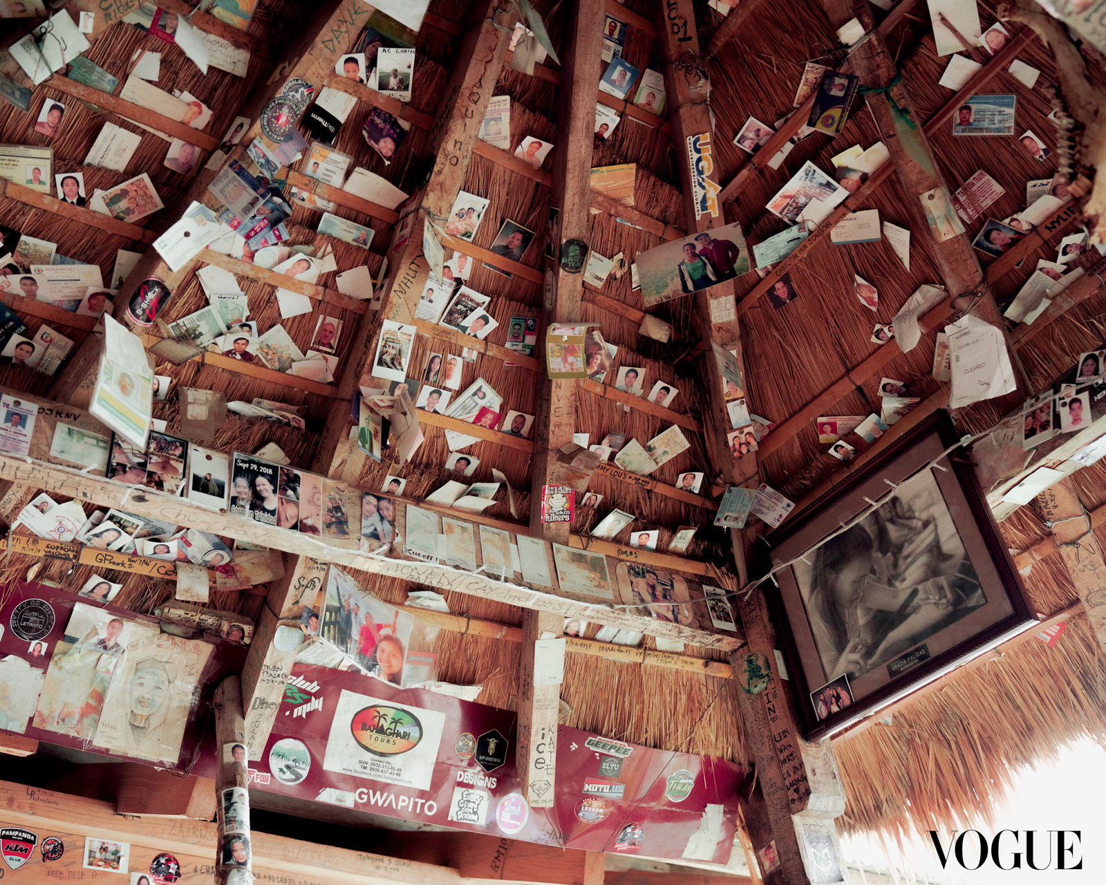 Mementos from travelers adorn the thatched roof of Grace Palicas’ pagbabatok tattoo studio