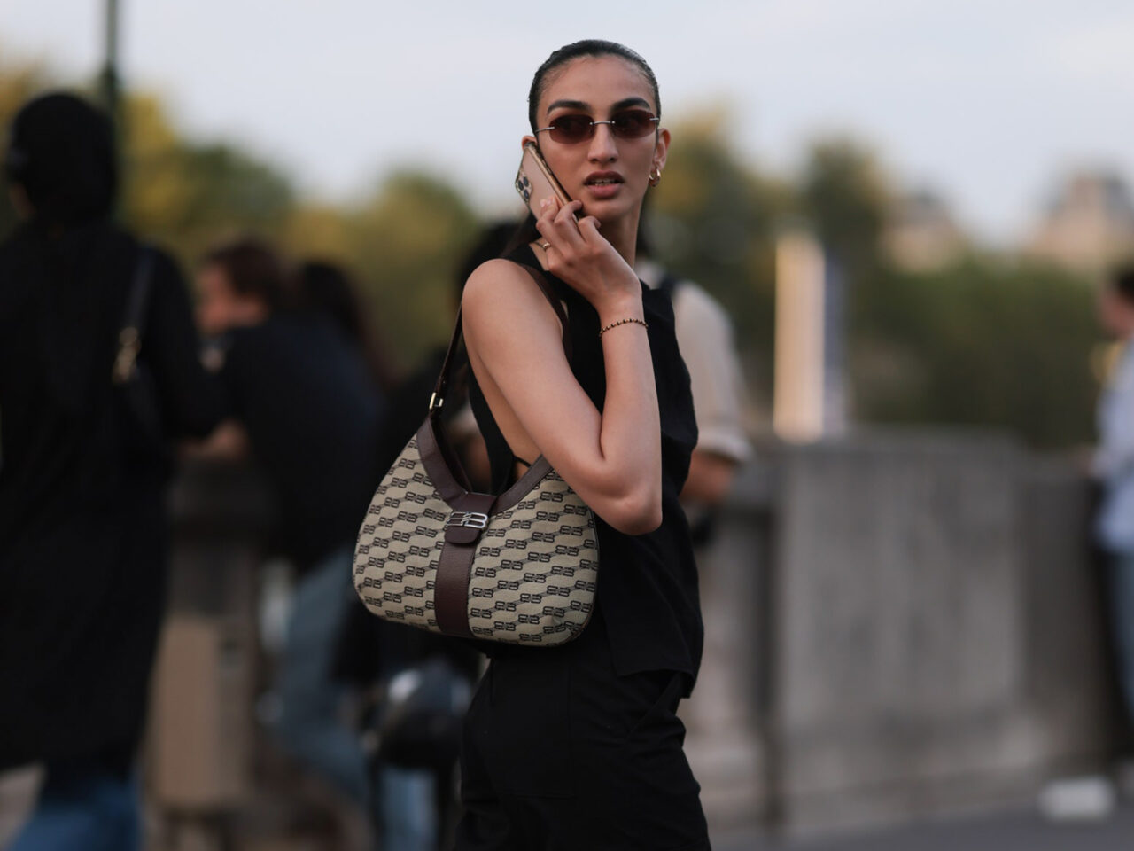woman walking on the phone wearing black loafers and white socks