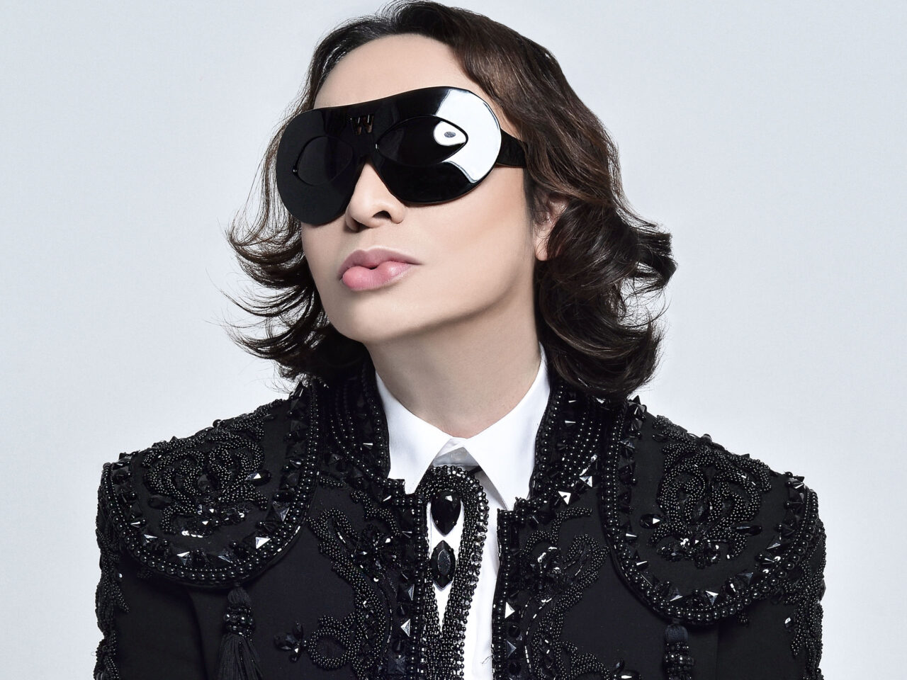 Michael Cinco wearing black oversized glasses in beaded black blazer