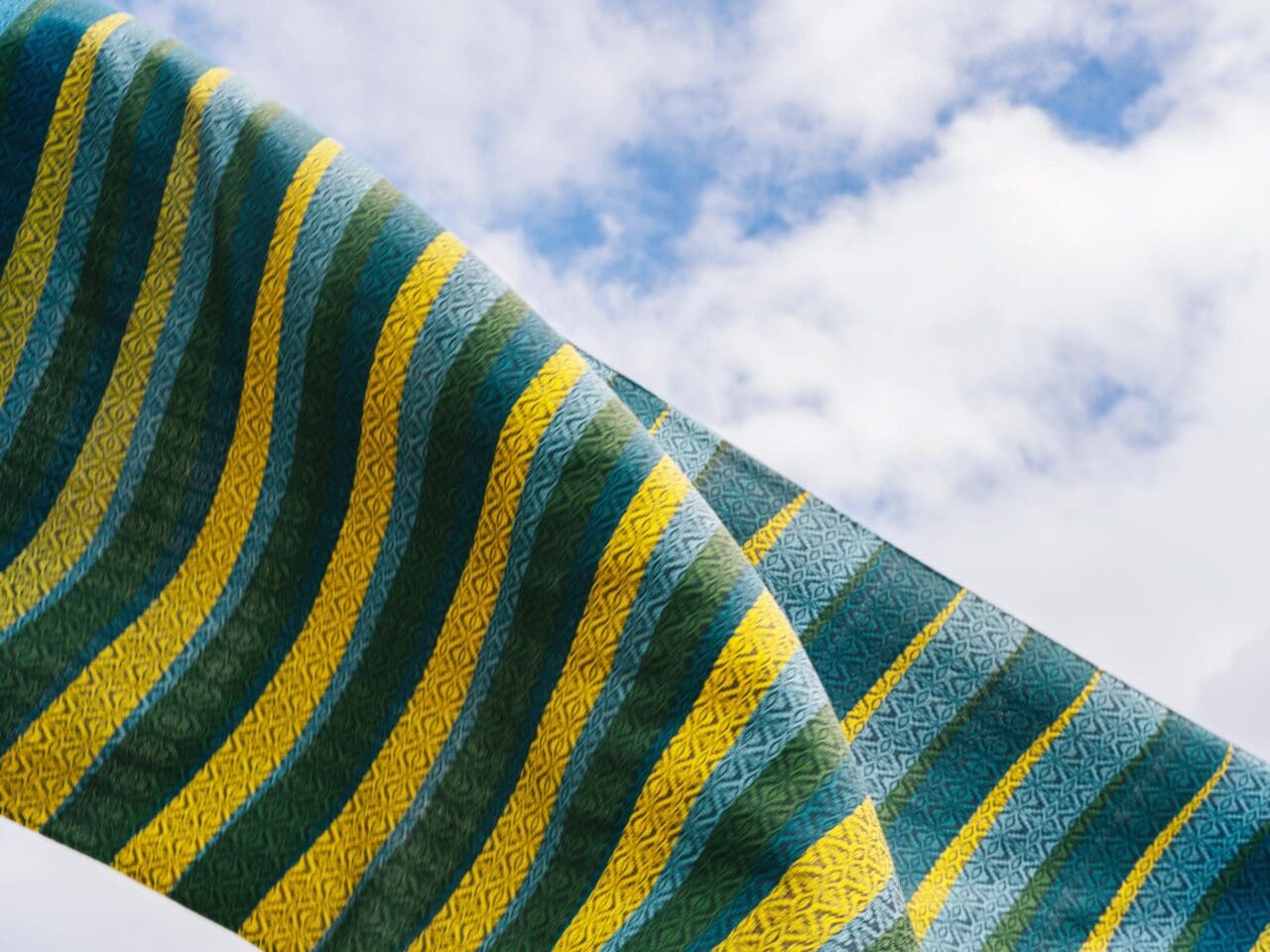 A weave pattern created by Iloilo's Baraclayan Weavers Association in Cebu Pacific's motif of blue, green, and yellow.