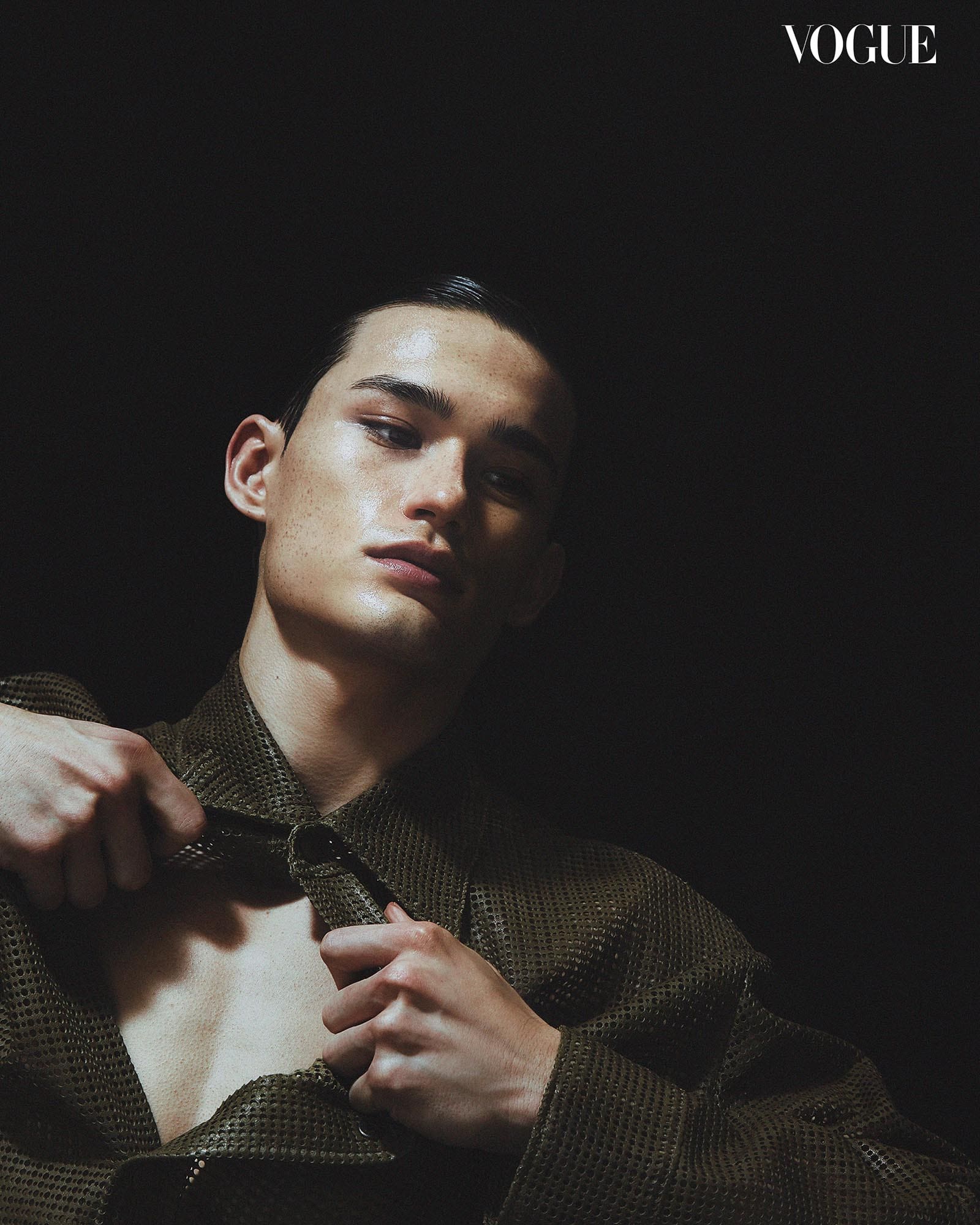 A top-down shot captures Alex Schlab as he parts his shirt open.