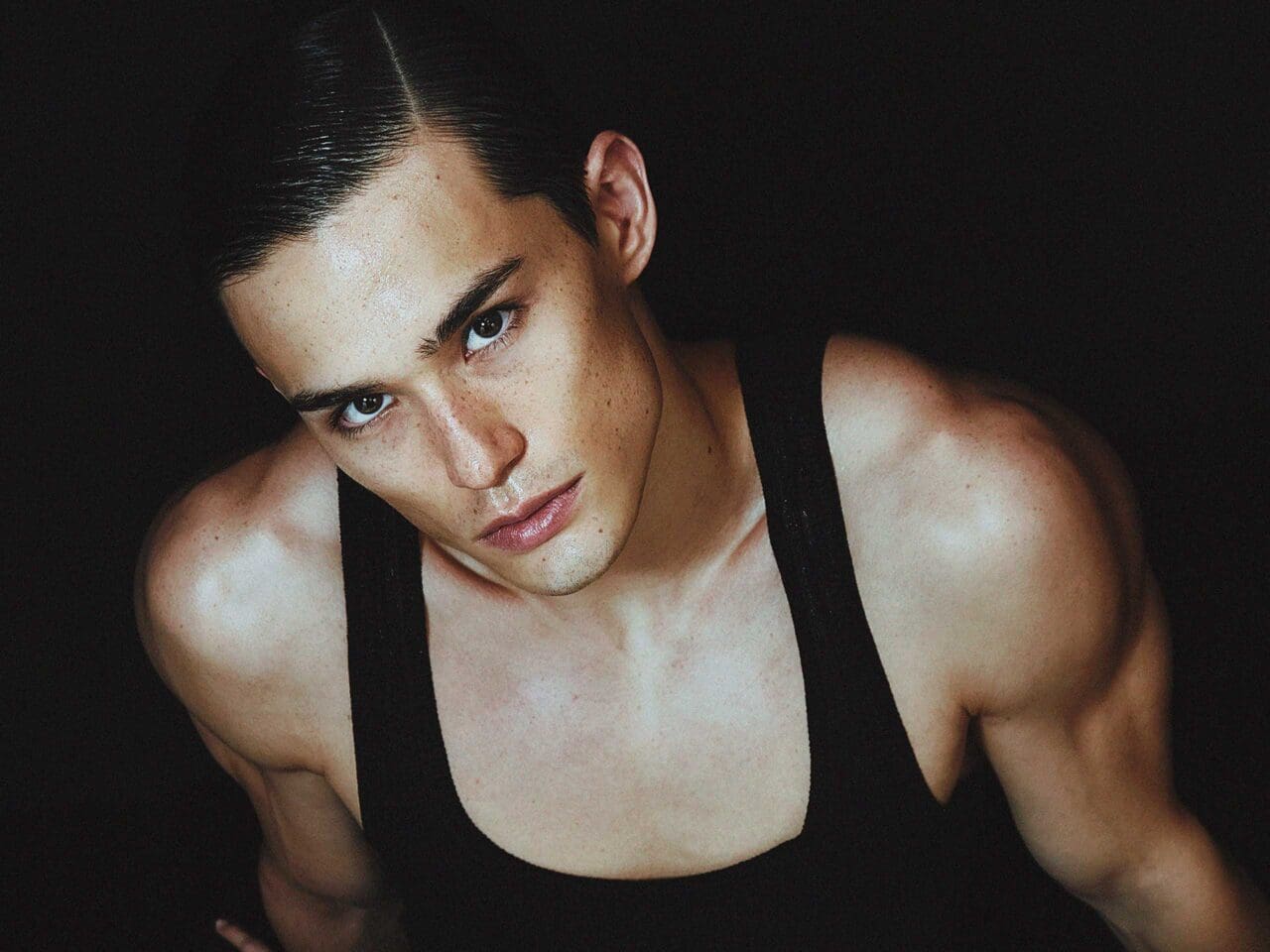 Top down photograph of Alex Schlab in a black tank top.