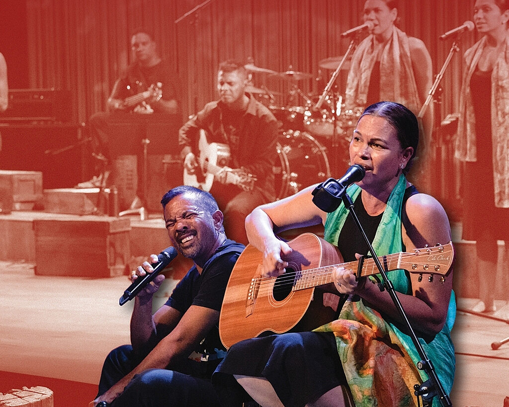 A group of musicians performing on a brightly coloured stage.